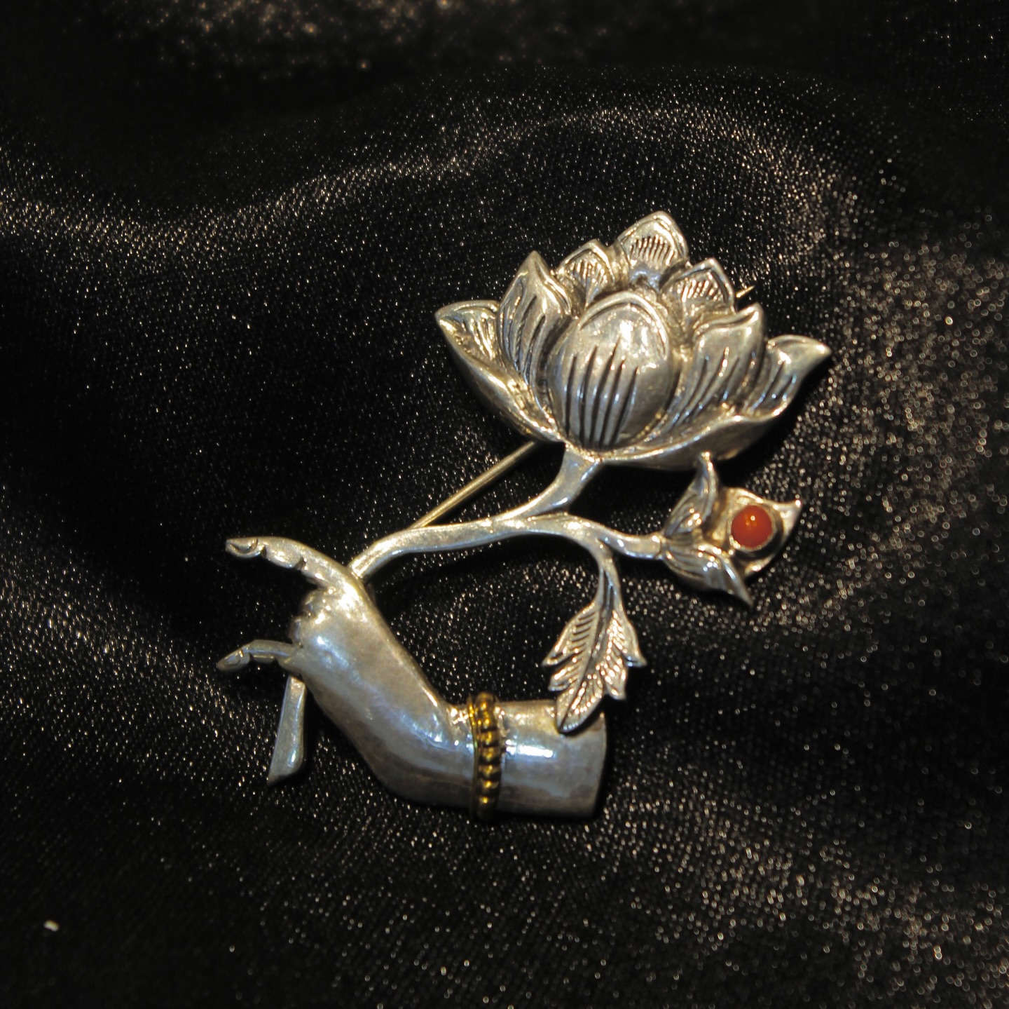 This silver brooch captures the divine grace of a Bodhisattvas hand holding a lotus embodying wisd - View 1