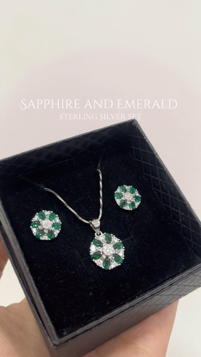 Timeless deep blue sapphire and vivid emerald set in shimmering silver. - View 1